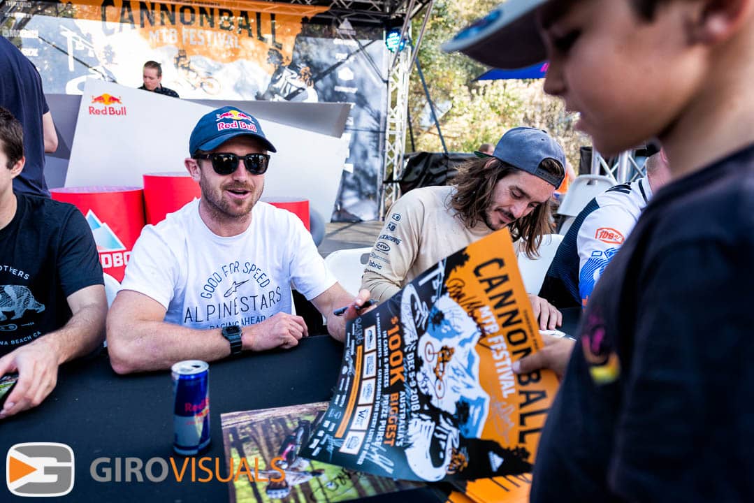 Brook Macdonald signs a  poster for young fan during the 2018 Thredbo Cannonball MTB Festival