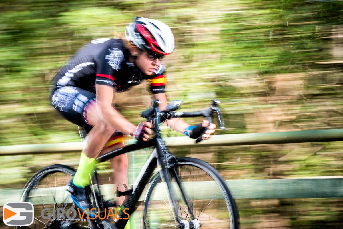 Road cyclist sprints for the line in a blur of power and speed.