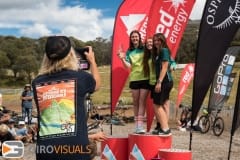 A parent takes a photo of her children on top of a podium during the Thredbo Interschools.